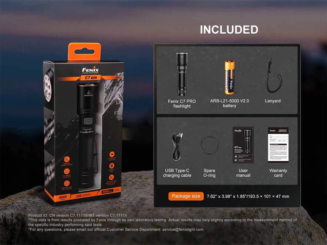 Boxed Fenix C7 Pro flashlight with orange accents, shown with included accessories: battery, lanyard, USB-C cable, spare O-ring, user manual, and warranty card on a rocky backdrop.