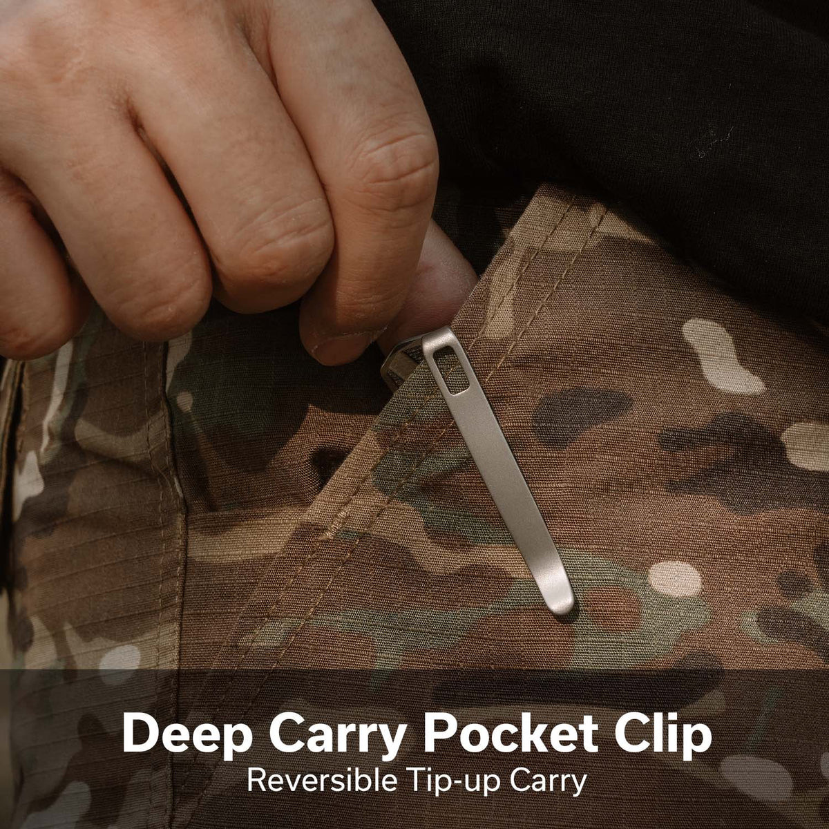 Metal deep-carry pocket clip being attached to camo fabric, showing a reversible tip-up carry design