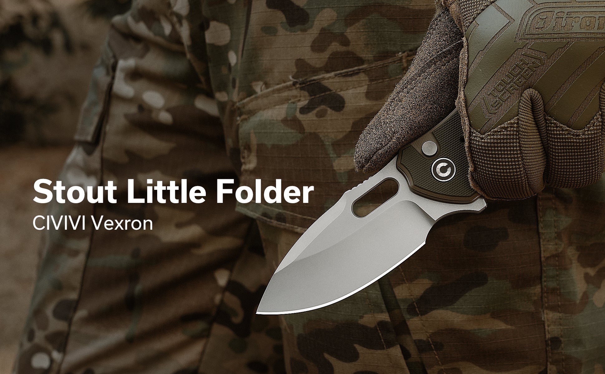 Close-up of a folding knife blade and textured handle held by a gloved hand against camouflage fabric backdrop.