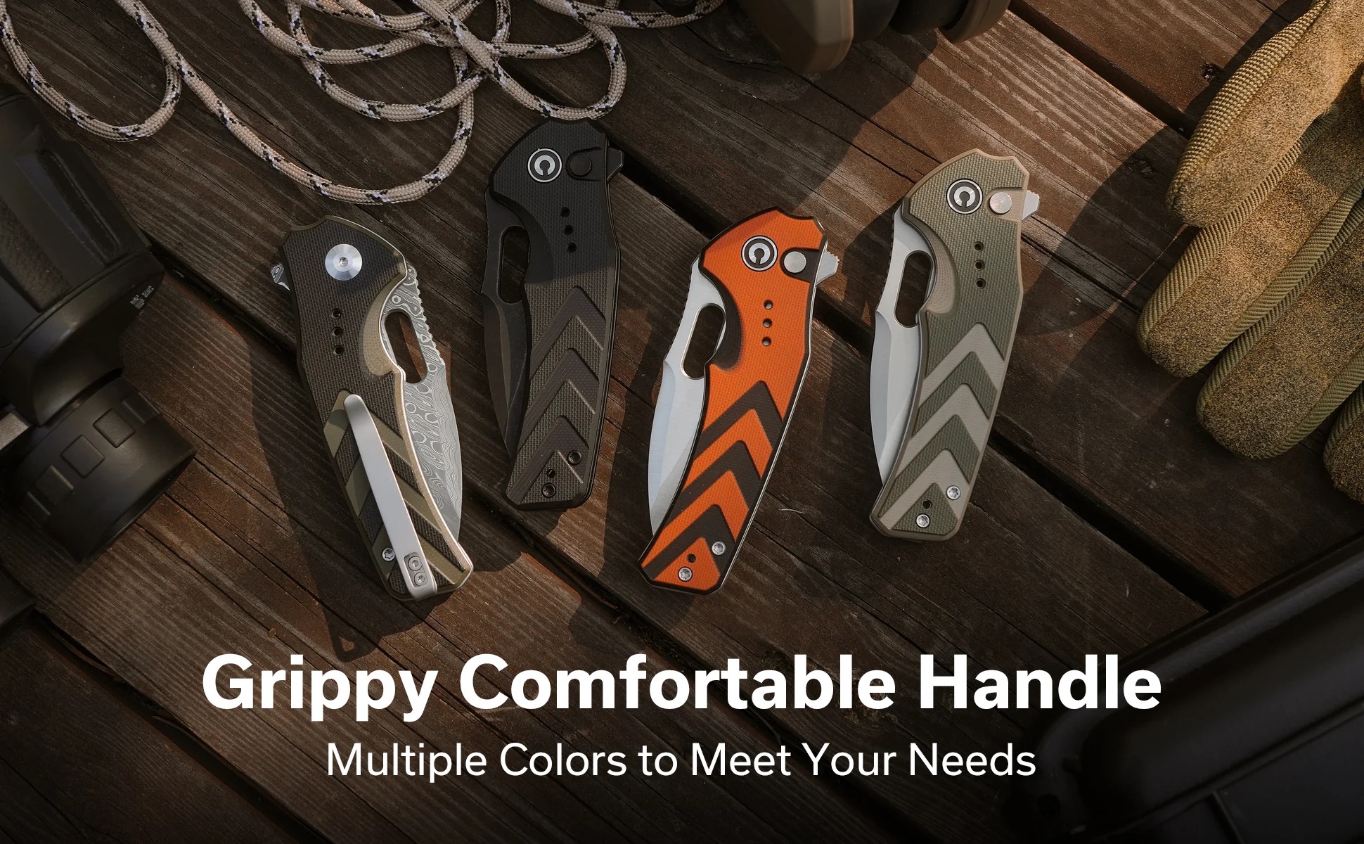 Five folding knives with textured handles in black, orange, gray, and olive laid out on a weathered wooden surface.