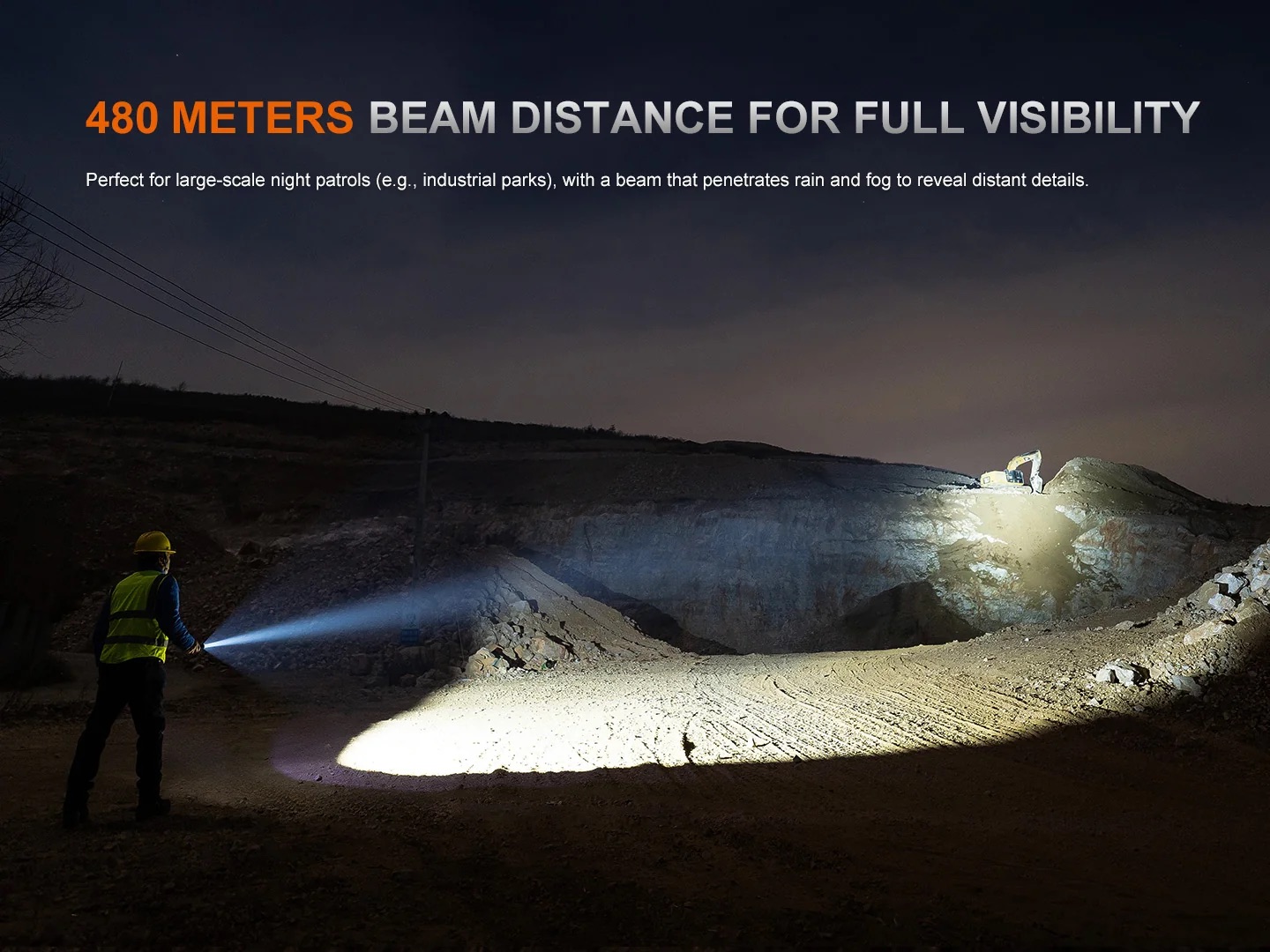Nighttime construction scene with a worker in a high-visibility vest and helmet shining a flashlight across a rocky quarry hillside.
