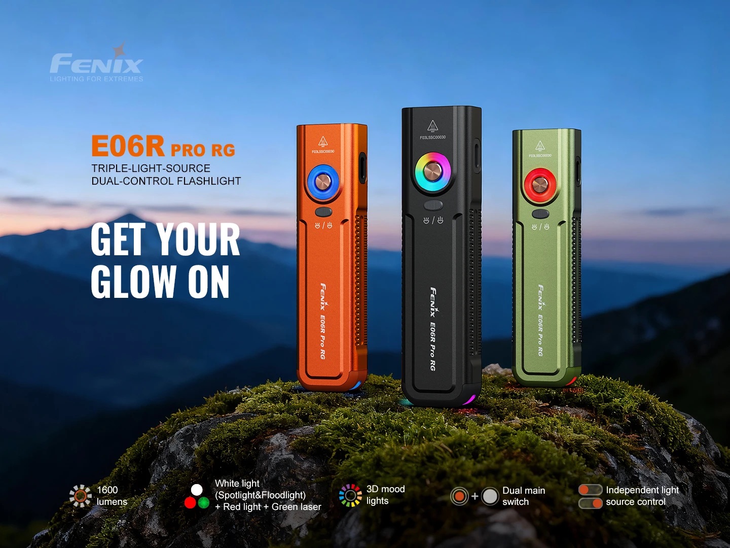 Three Fenix E06R Pro RG flashlights in orange, black, and green stand on a rocky hill with a mountainous sunset background, 'GET YOUR GLOW ON' text visible on left.