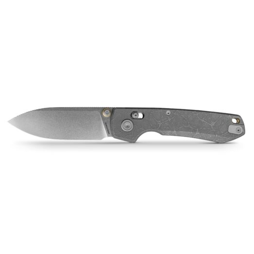 Partial view of a grey folding knife with a textured handle, blade extended to the left against a white background