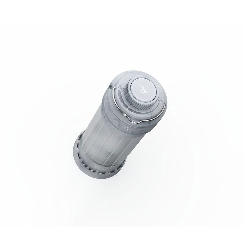 Top-down view of a gray cylindrical device with a twist-off cap and ribbed grip, translucent body, on a white background.