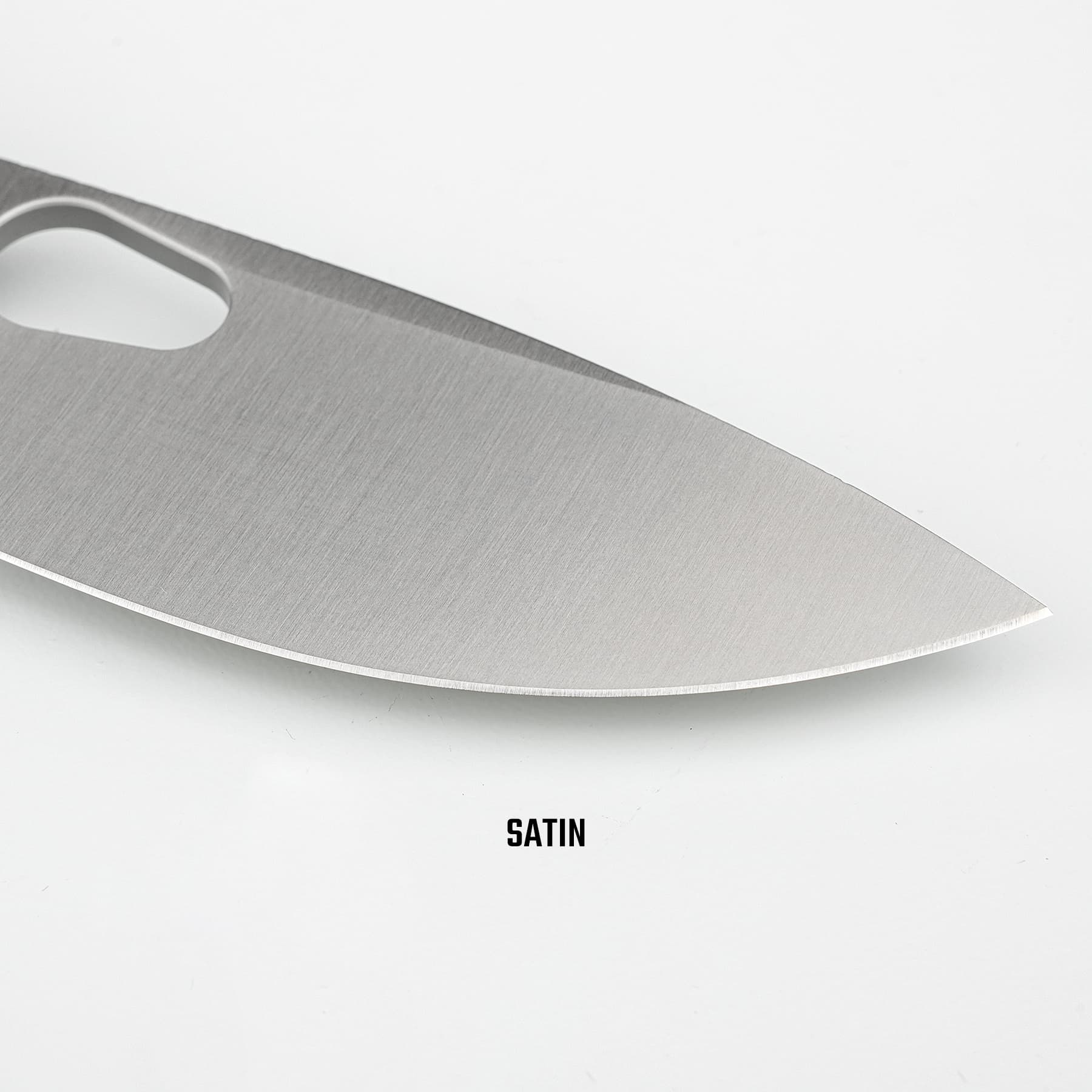 Close-up of a satin-finished steel blade with a rounded cutout near the top edge.