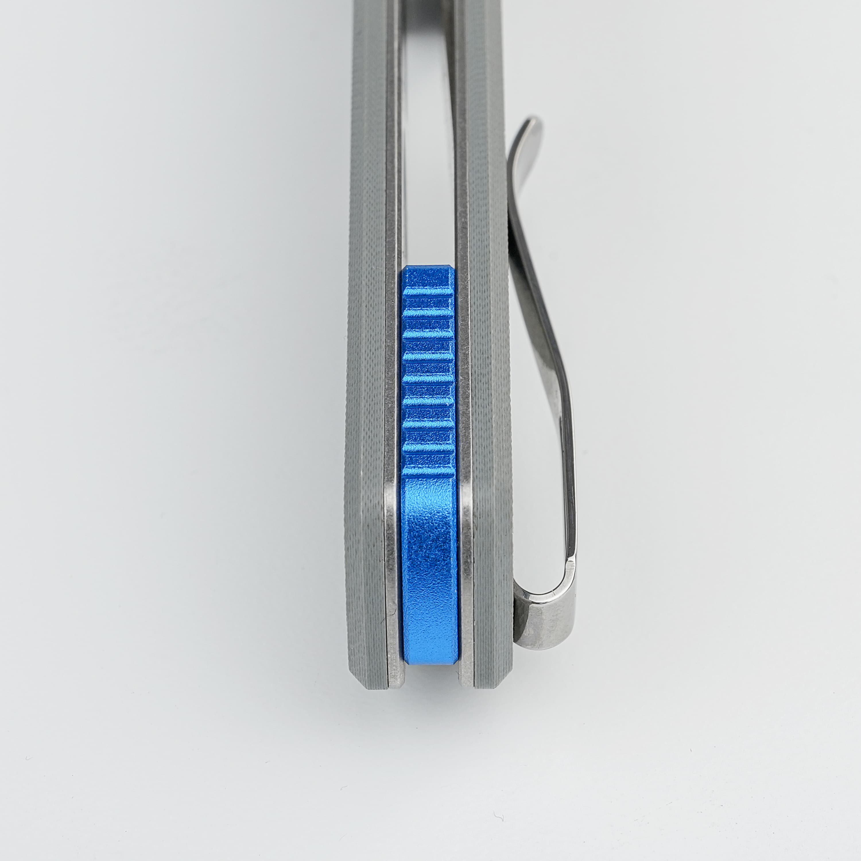 Close-up of a metal sliding clamp with a blue textured adjustment wheel and a curved lever on the side.