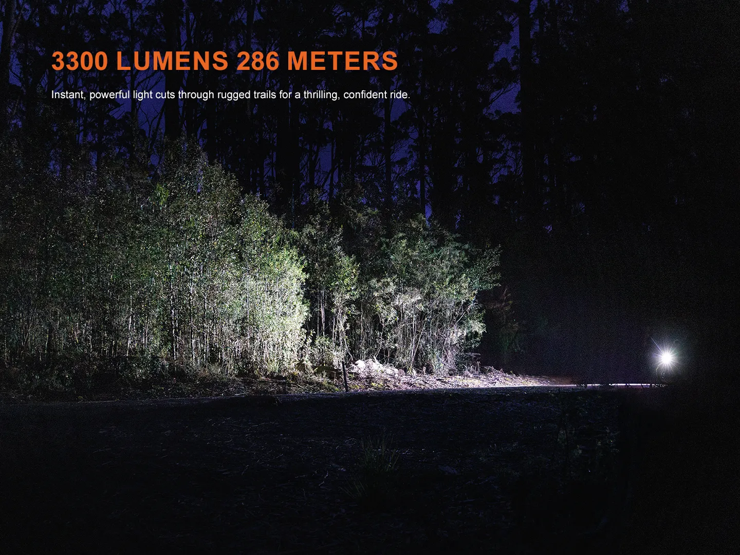 Night forest scene at night with a beam of light along a dirt road and orange text reading '3300 LUMENS 286 METERS' plus a smaller subtitle line about instant, powerful light.