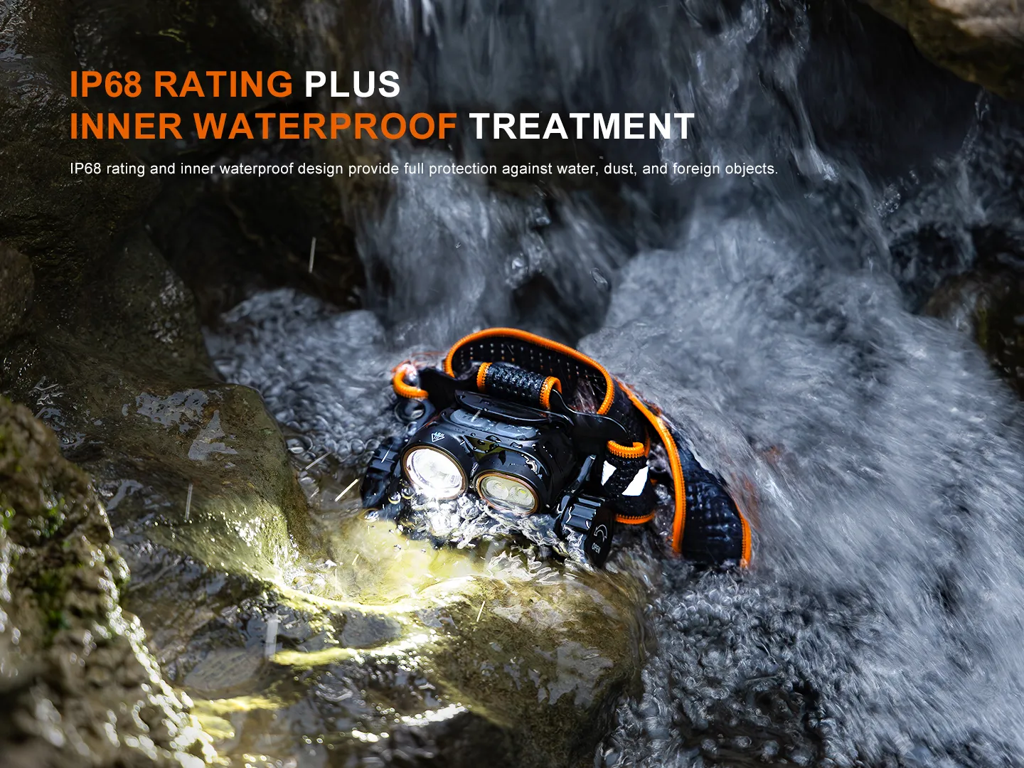 Rugged waterproof flashlight with orange accents submerged in a rocky stream.