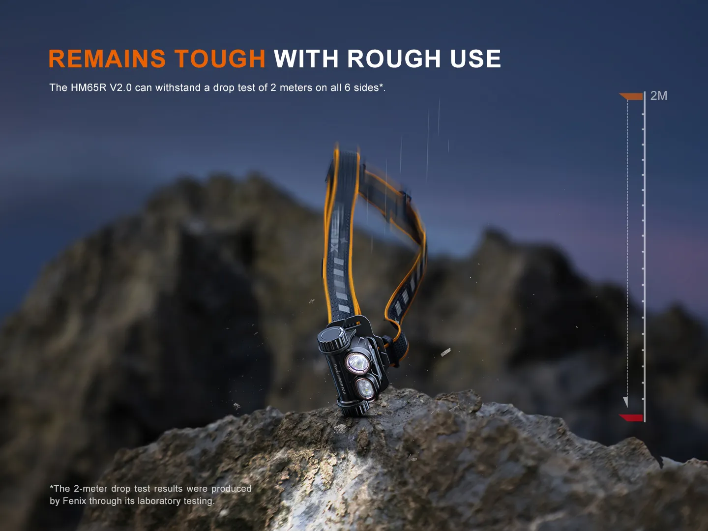 Headlamp strapped to a rocky surface at dusk with bold orange headline: 'REMAINS TOUGH WITH ROUGH USE' and a vertical 2M scale on the right side.