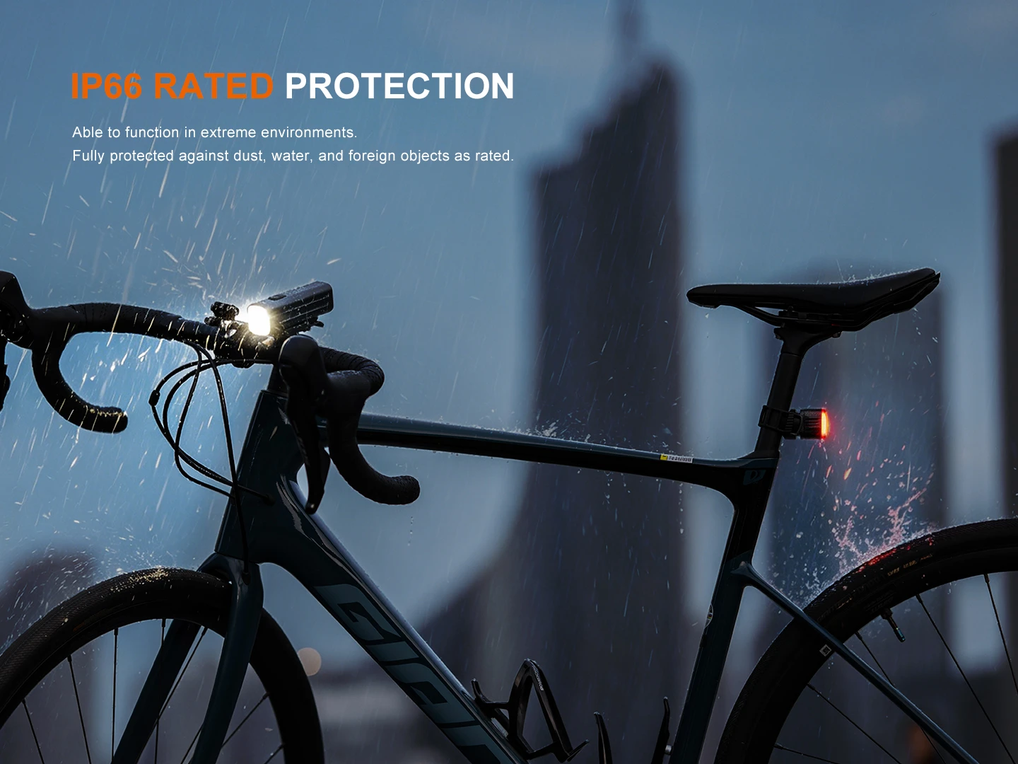 Road bike in heavy rain with orange 'IP66 RATED PROTECTION' headline and white subtitle text.