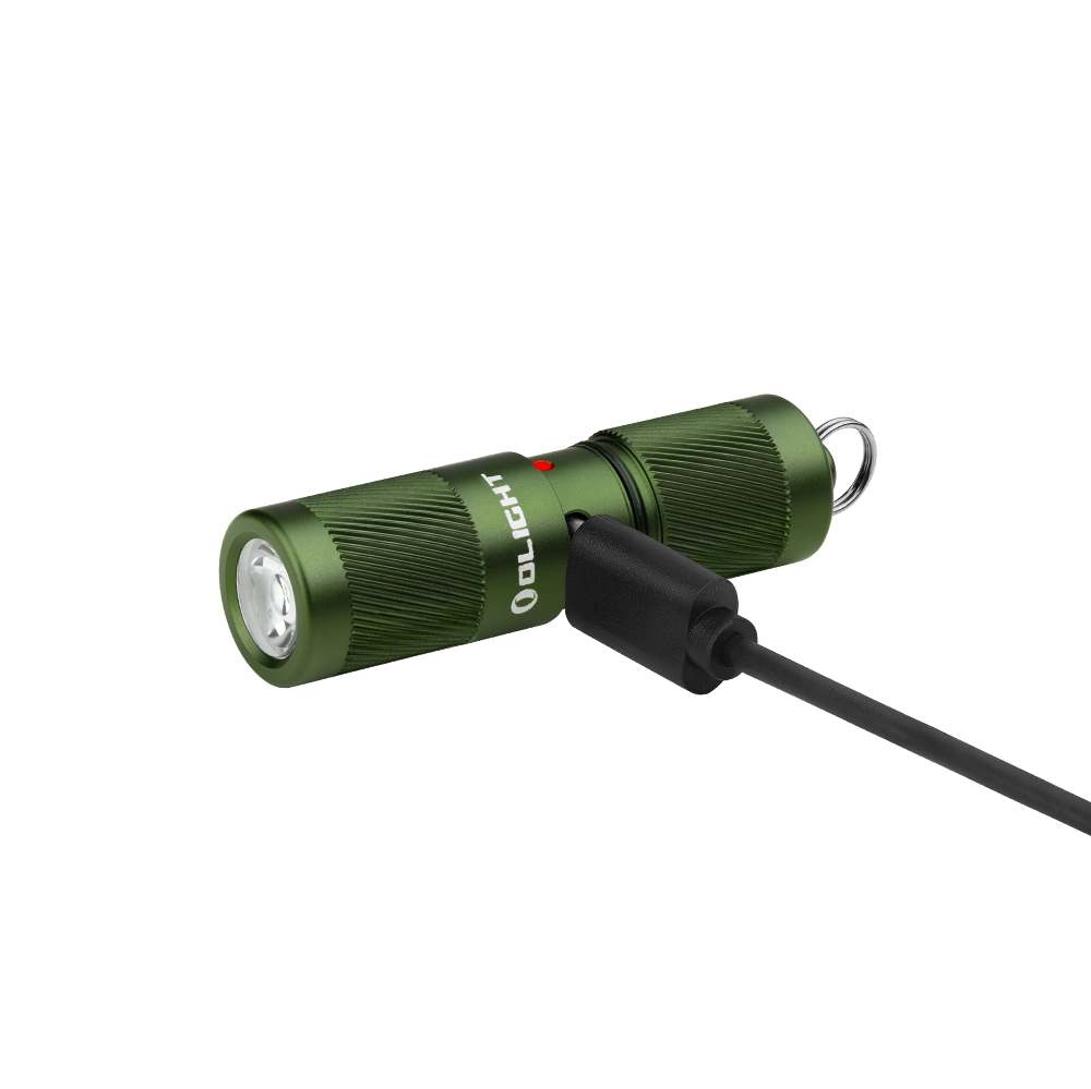 Green compact flashlight with knurled grip and charging cable attached, laying on its side with loop attachment visible